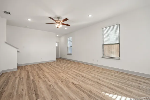 wooden floor in an empty room with a window