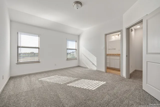 an empty room with windows and closet