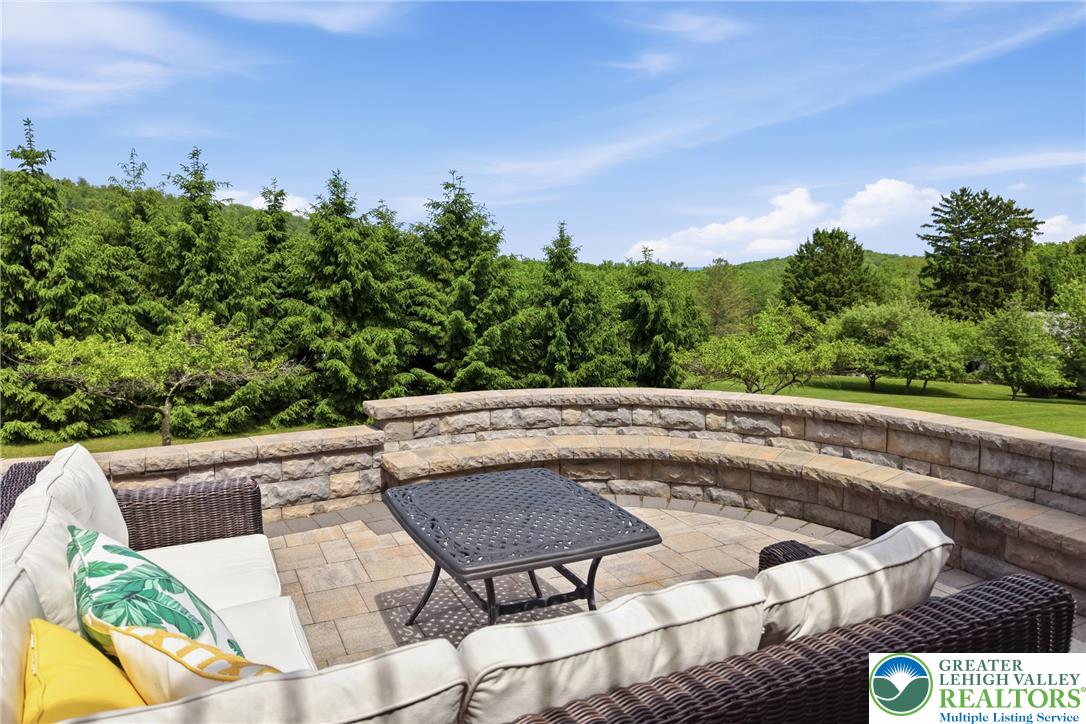115 West Butternut Road Hellertown, PA 18055 - Photo 81 of 97 An inviting stone patio with built-in seating offers peaceful outdoor living.