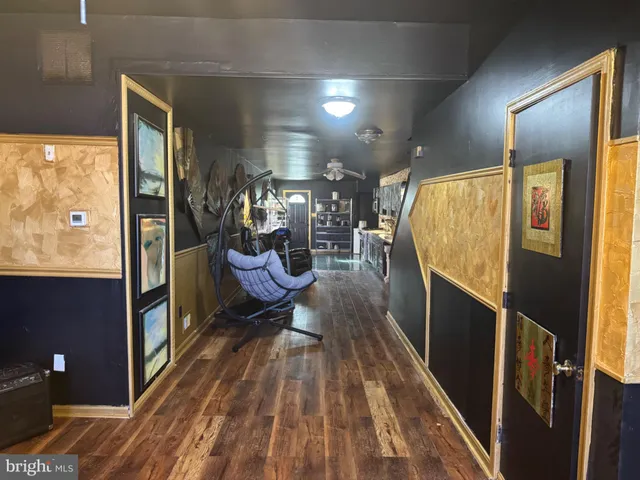 a view of a living room with wooden floor