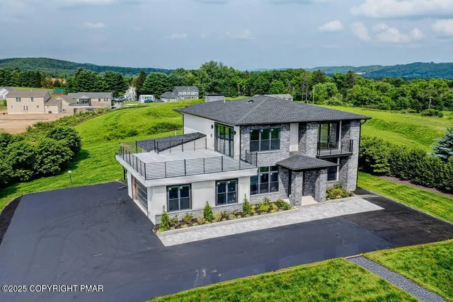 an aerial view of a house with a yard table and chairs