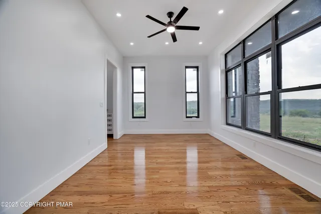 wooden floor in an empty room with a window