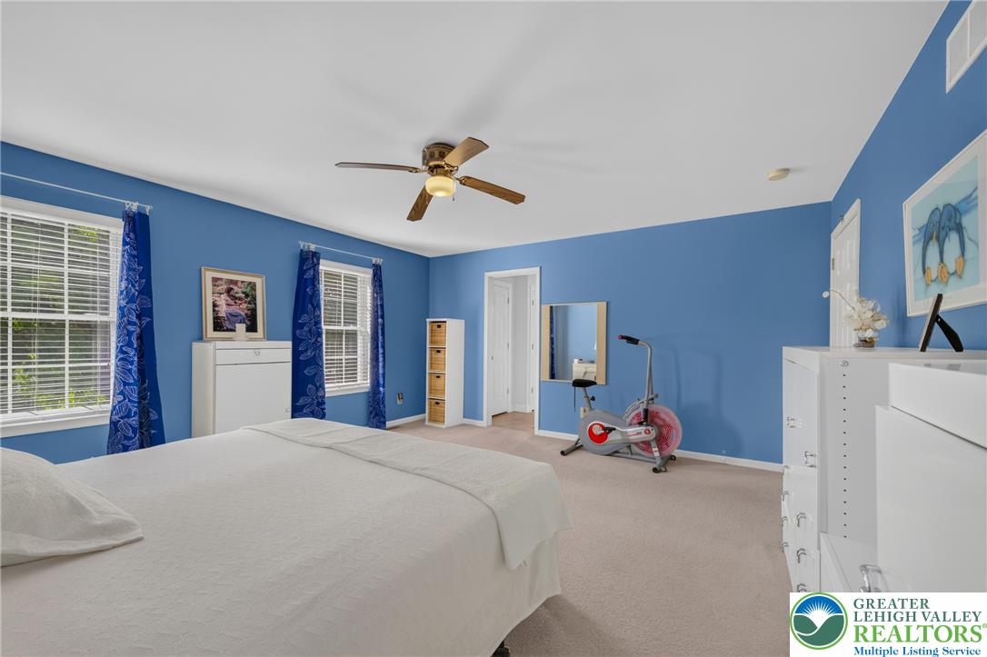 1702 Red Bud Road Quakertown, PA 18951 - Photo 35 of 68 Well-lit sleeping quarters with a ceiling fan, plush carpeting, and multiple windows allowing for natural light.