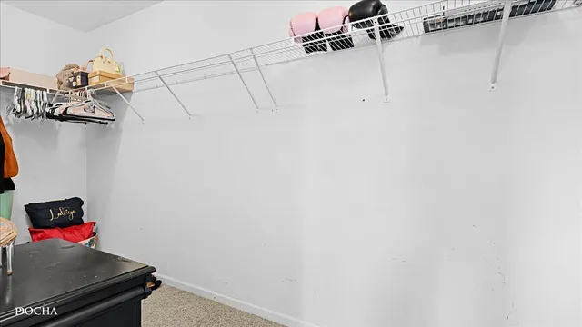 a room with water heater and utility racks on the wall