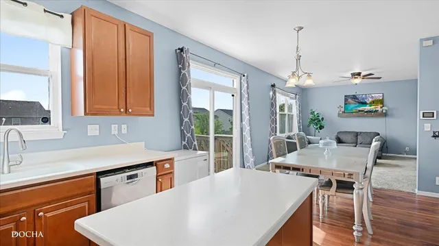 a kitchen with a table chairs and wooden floor