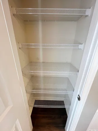 a view of staircase with white walls and a window