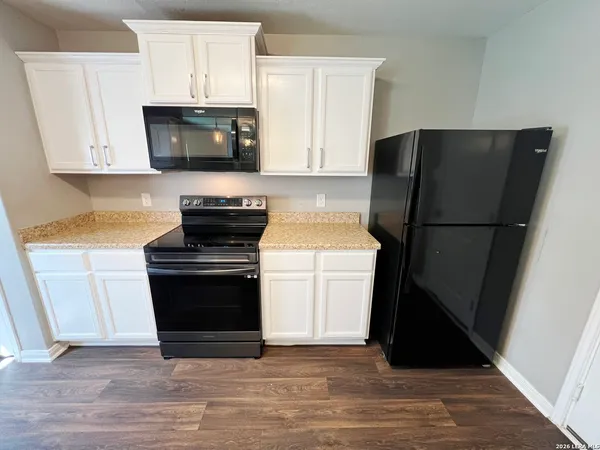 a kitchen with a stove and a refrigerator