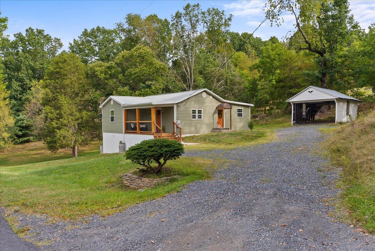 765 Union Church Road Churchville, VA 24421 - Photo 2 of 35 a front view of a house with a garden and trees