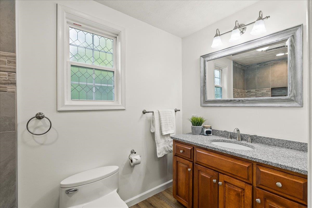 765 Union Church Road Churchville, VA 24421 - Photo 25 of 35 a bathroom with a granite countertop toilet sink and mirror