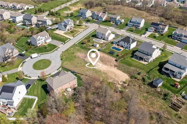 an aerial view of a house with a yard and lake view