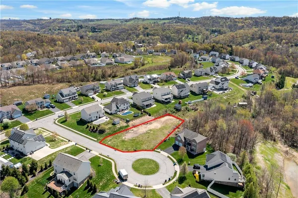 an aerial view of residential house with outdoor space and parking