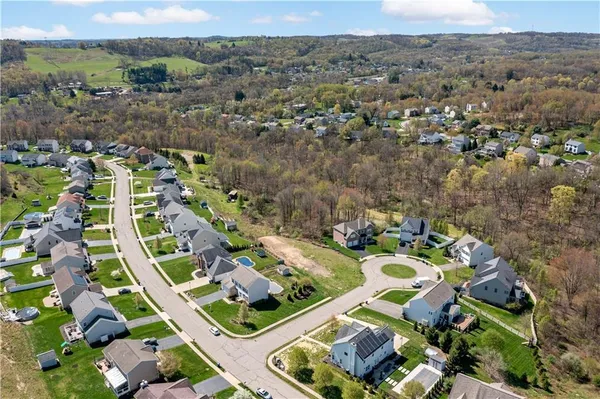 an aerial view of a house with a mountain