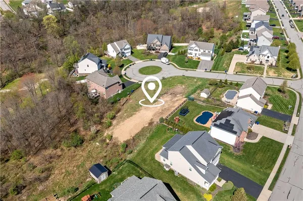 a view of a house with a big yard and a large tree