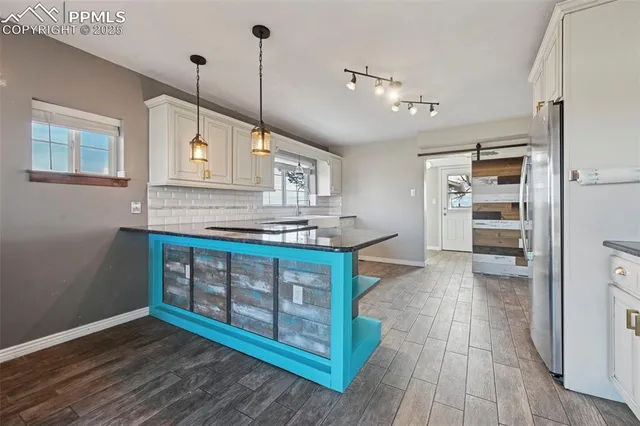a view of kitchen with sink window and refrigerator