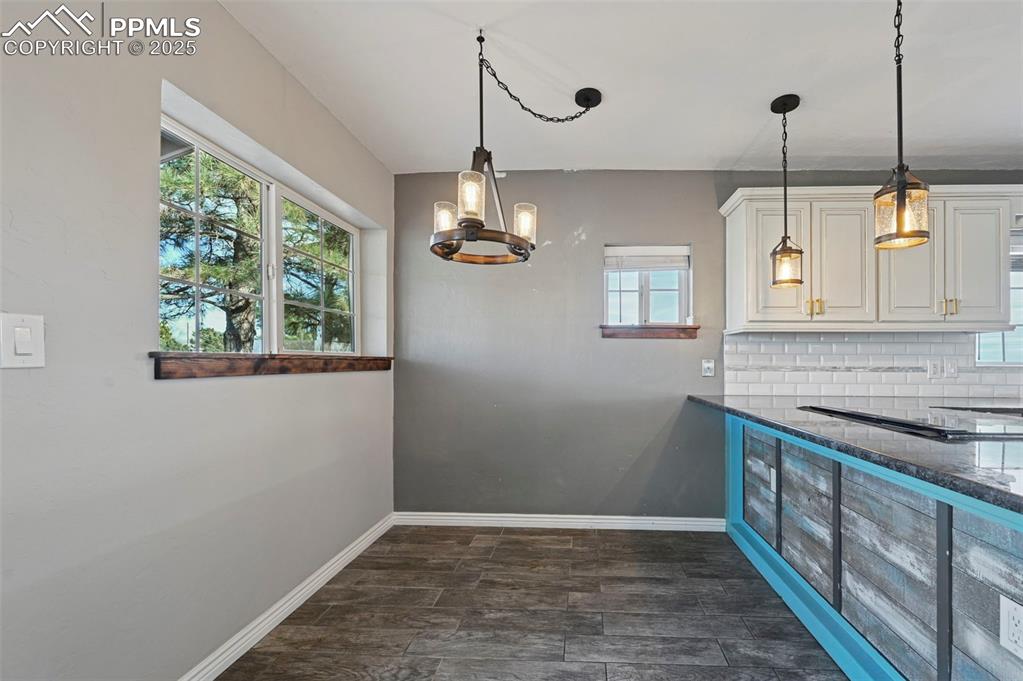 7865 Wilson Road Fountain, CO 80817 - Photo 16 of 46 a kitchen with stainless steel appliances granite countertop cabinets a sink a window and a wooden floor