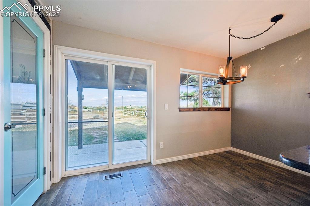 7865 Wilson Road Fountain, CO 80817 - Photo 17 of 46 a view of a room with wooden floor and windows