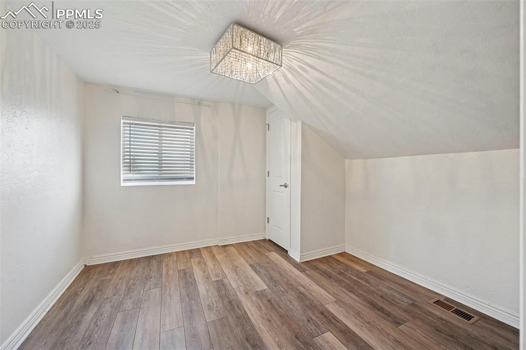 7865 Wilson Road Fountain, CO 80817 - Photo 19 of 46 wooden floor in an empty room with a window