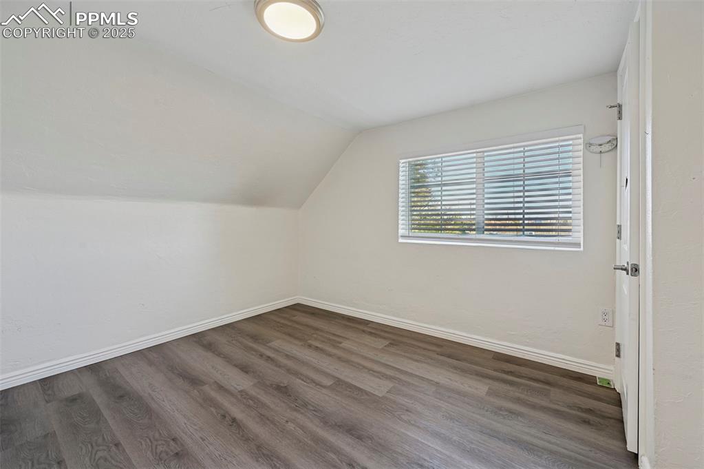 7865 Wilson Road Fountain, CO 80817 - Photo 20 of 46 an empty room with wooden floor and windows