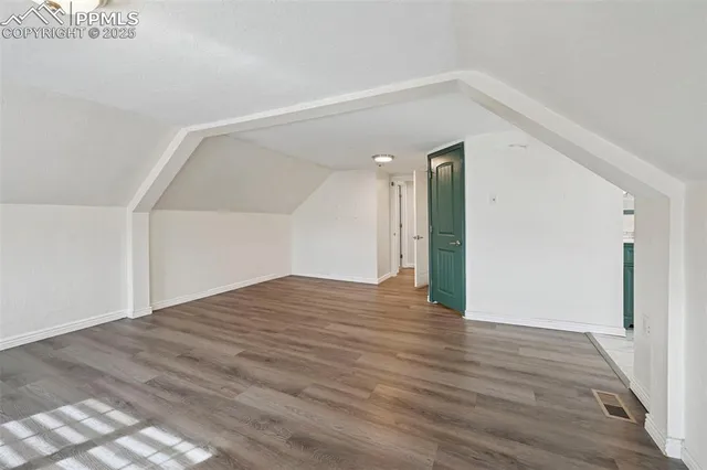 a view of a big room with wooden floor and staircase