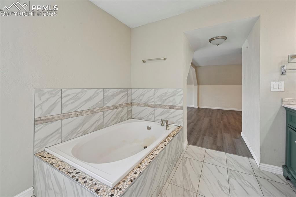 7865 Wilson Road Fountain, CO 80817 - Photo 25 of 46 a bathroom with a bathtub and a shower