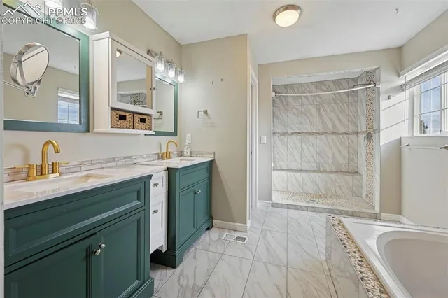 a bathroom with a tub sink and mirror