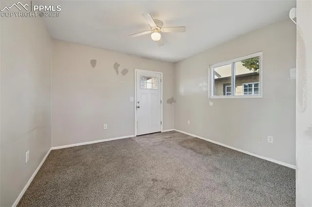 a view of an empty room with a ceiling fan