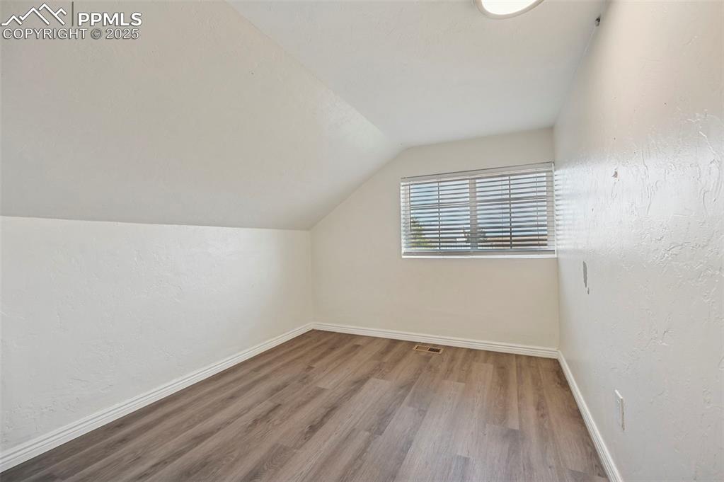 7865 Wilson Road Fountain, CO 80817 - Photo 37 of 46 an empty room with wooden floor and windows