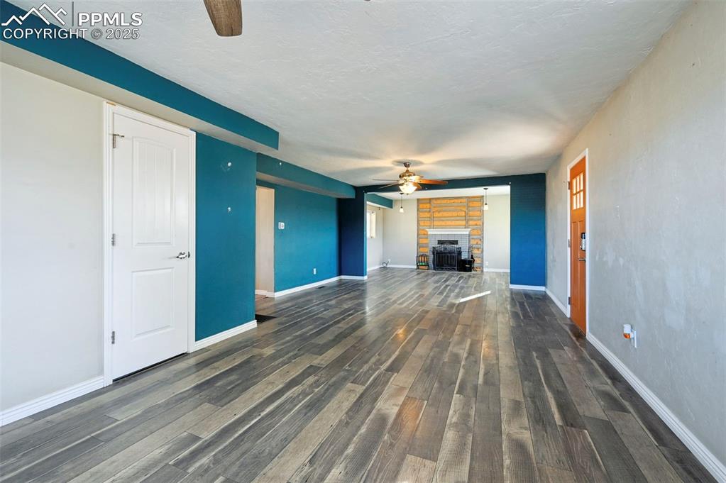 7865 Wilson Road Fountain, CO 80817 - Photo 9 of 46 a view of a room with wooden floor and a window