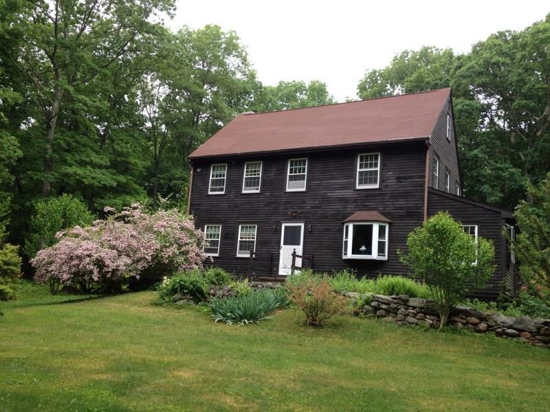 a front view of a house with a garden and plants