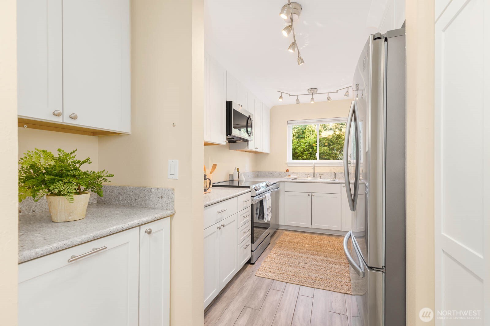 13279 15th Avenue Northeast, Unit B20 Seattle, WA 98125 - Photo 11 of 32 a kitchen with a white stove top oven and sink