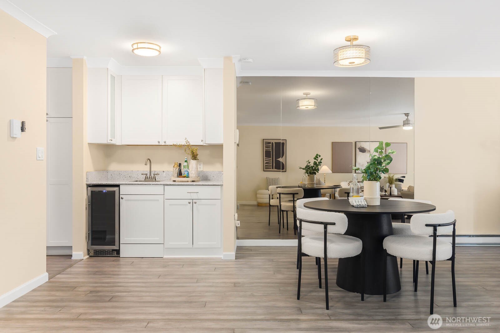 13279 15th Avenue Northeast, Unit B20 Seattle, WA 98125 - Photo 9 of 32 a kitchen with a dining table chairs and white cabinets