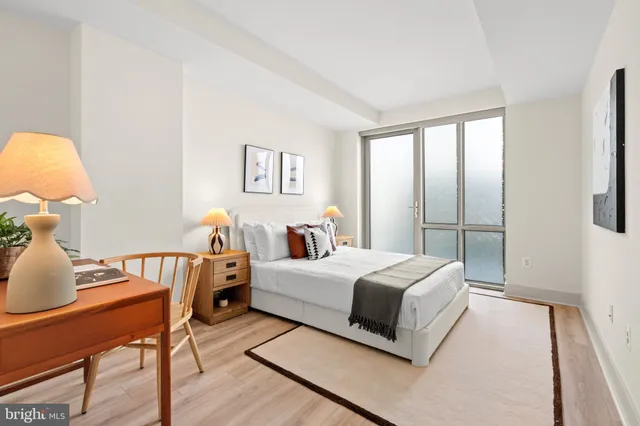 a bedroom with a bed and wooden floor