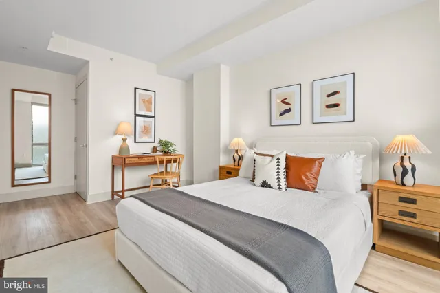 a bedroom with a bed and a lamp on table