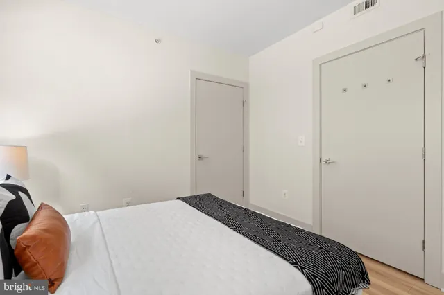 a bedroom with a bed and a lamp