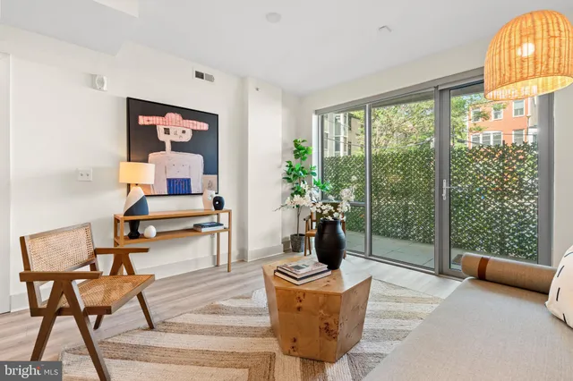a living room with furniture and a floor to ceiling window