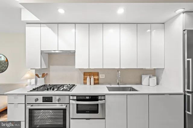 a kitchen with a stove a sink and a refrigerator