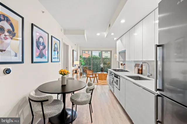 a kitchen with stainless steel appliances kitchen island granite countertop a sink and cabinets