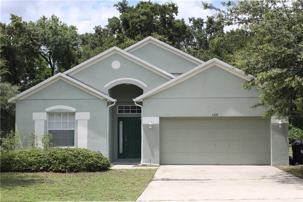 a front view of a house with garage