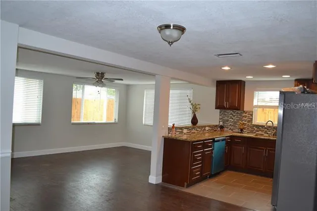 a kitchen with stainless steel appliances granite countertop a sink stove and cabinets
