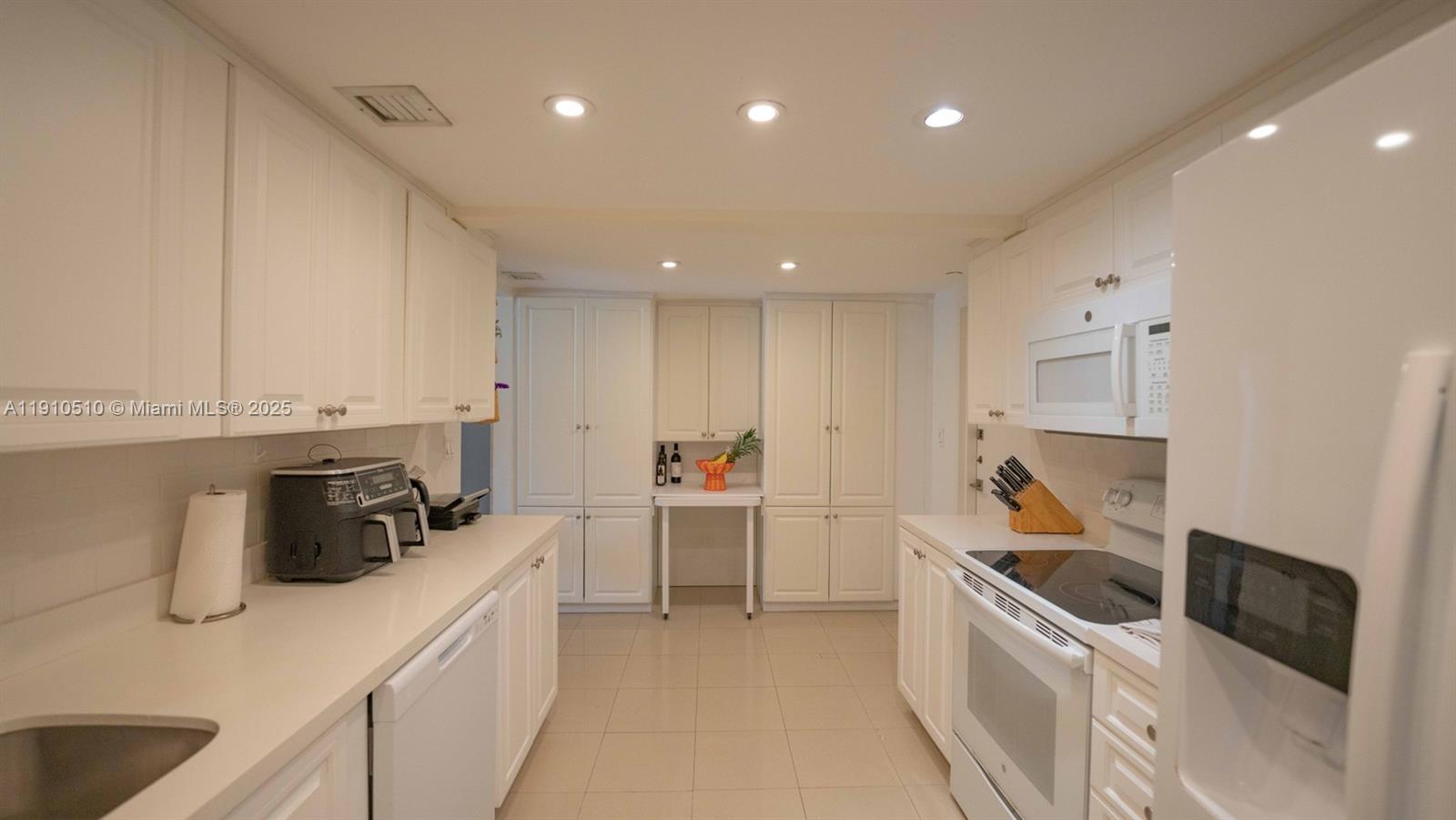 199 Ocean Ln Drive, Unit 313 Key Biscayne, FL 33149 - Photo 5 of 9 a kitchen with refrigerator and cabinets