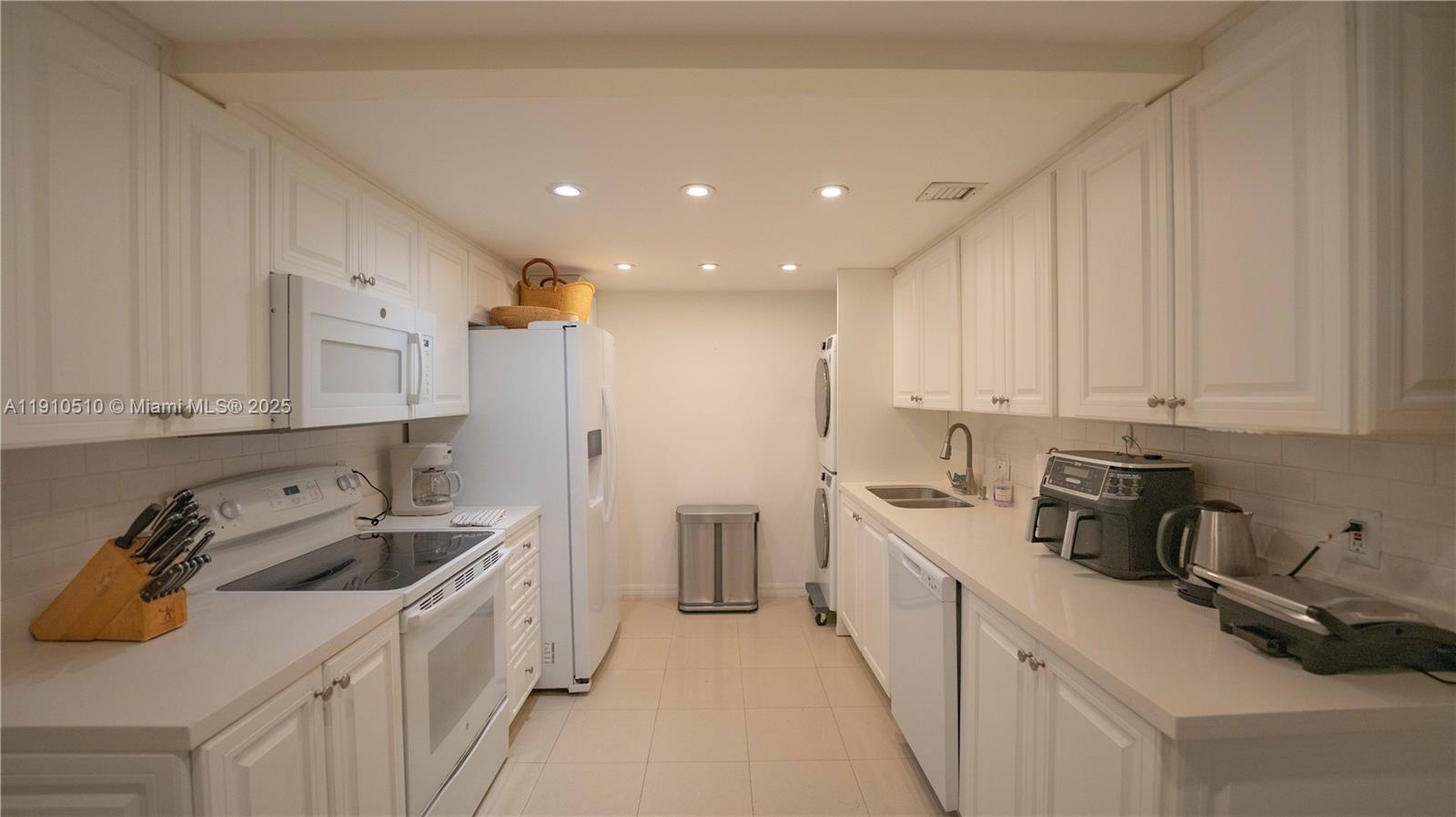 199 Ocean Ln Drive, Unit 313 Key Biscayne, FL 33149 - Photo 6 of 9 a kitchen that has a sink and a stove