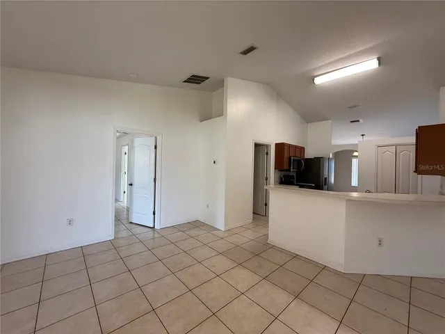 a kitchen with a refrigerator sink and wooden cabinets