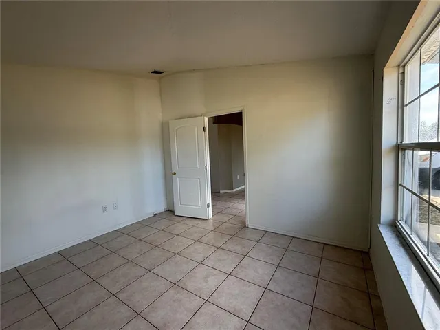 a bathroom with a sink and mirror with bathtub