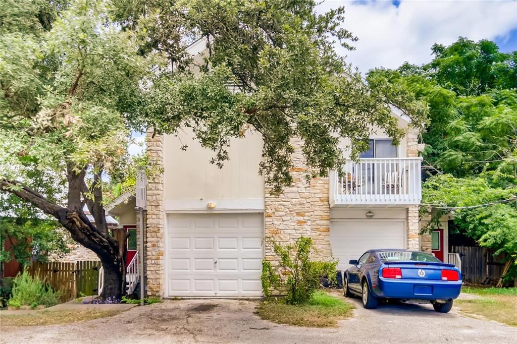 2500 Jones Road, Unit B Austin, TX 78745 - Photo 1 of 1 Mature trees shade a classic stone-accented facade featuring a private upper balcony.