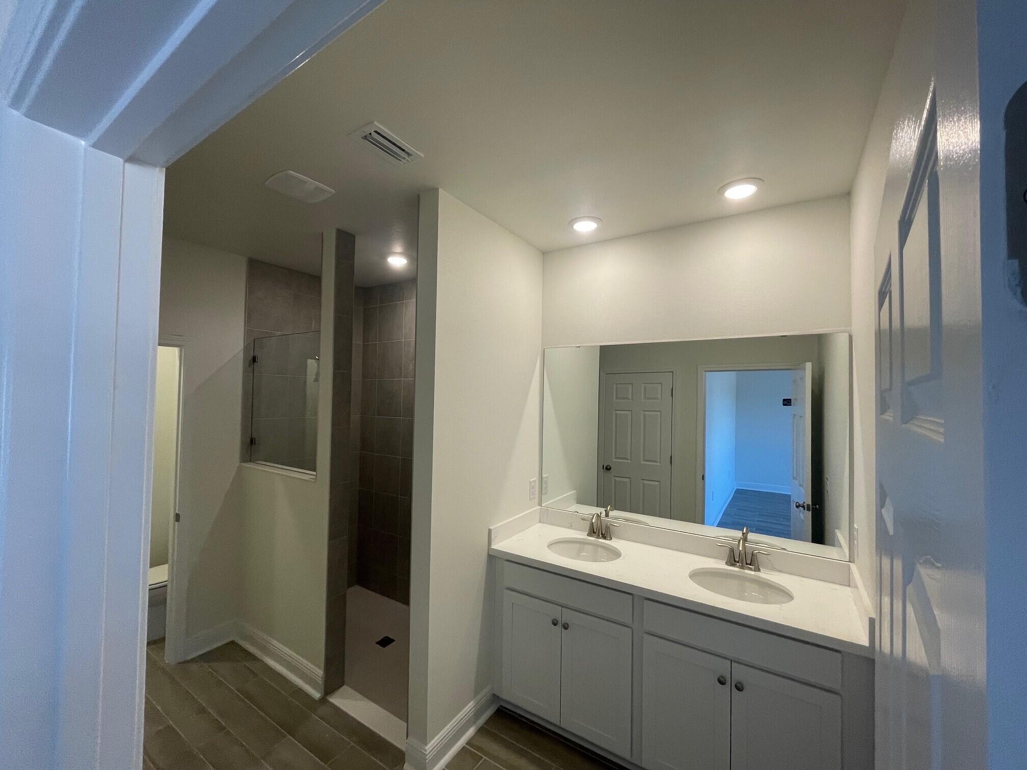 23 Splendor Run Ponce de Leon, FL 32455 - Photo 6 of 8 a bathroom with a double vanity sink and mirror