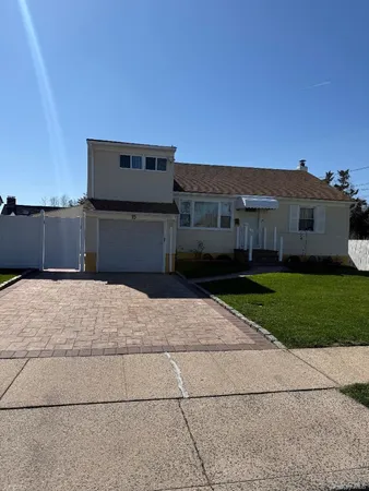 a front view of a house with a yard and a garage