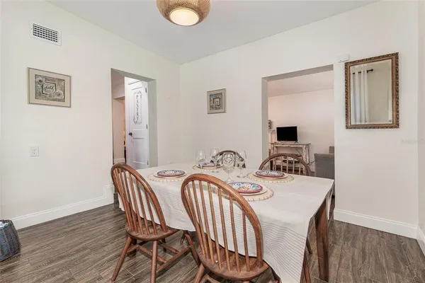 a view of a dining room with furniture and wooden floor