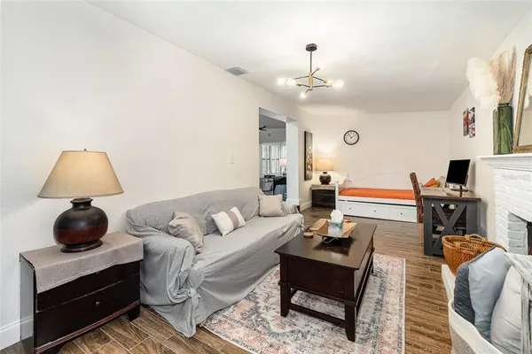 a living room with furniture and a chandelier