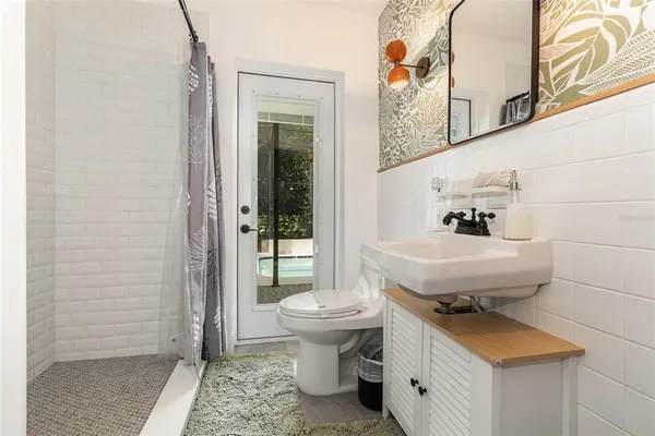 a bathroom with a sink toilet and shower