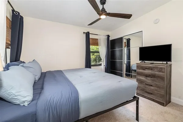 a bedroom with a bed and a flat screen tv